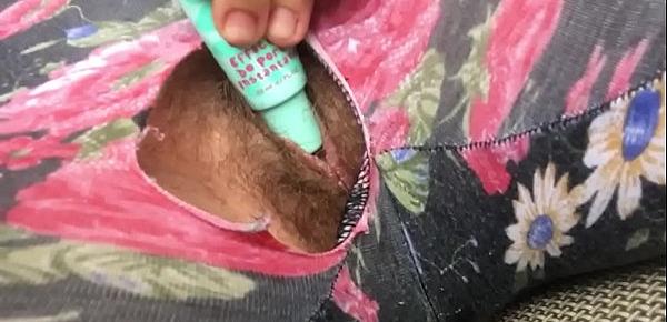  Ripped hole reveals a pissing and squirting little pussy